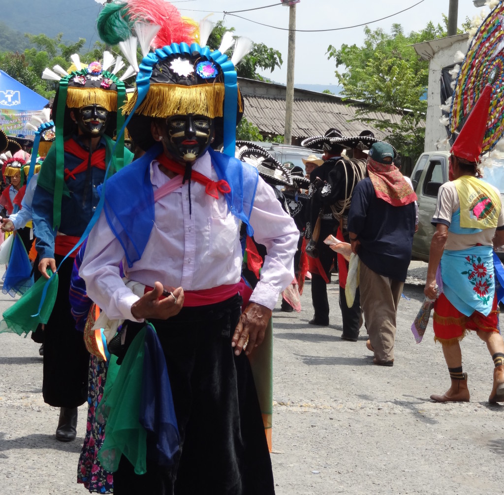 Totonacs performing La danza de los negrito  dressed in costumes influenced by colonial dress, and dancers with a snake motif around the waist. Patla festival, 2012
